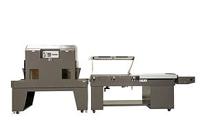 Automated packaging machine with conveyor belt and shrink wrap tunnel.