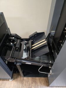 Open photo printer with visible paper trays and internal components.