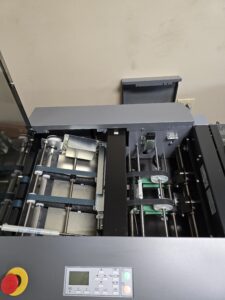 Inside a printer showing rollers and paper feeding mechanisms.