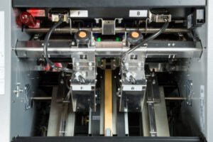 Close-up of a high-tech industrial machine with intricate metallic components.