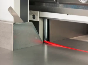 Industrial laser beam scanning a metal surface.