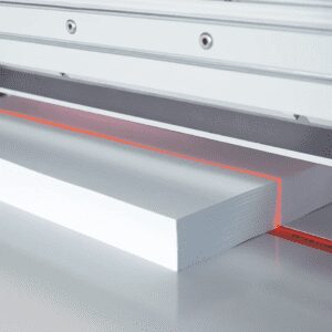 Laser cutting a sheet of white foam board.