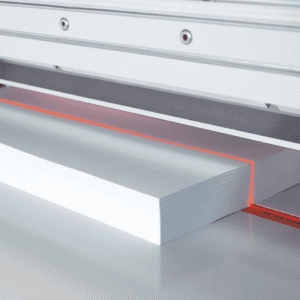 Laser cutting a sheet of white foam board.