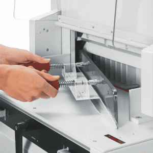 Person fixing or cleaning a printer's internal components.