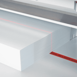 Stack of white paper sheets with a red measuring tape beside them.