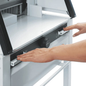 Person adjusting a knob on a modern industrial machine.