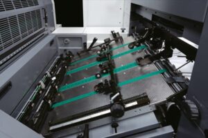 Industrial printing machine processing sheets.
